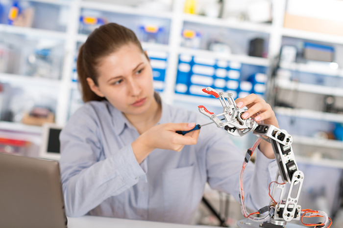 Young woman building Robotics in a lab