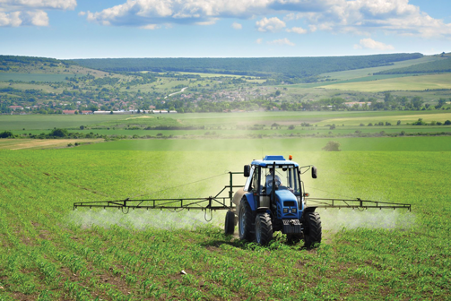 Tractor fumigating and watering commercial agricultural crops